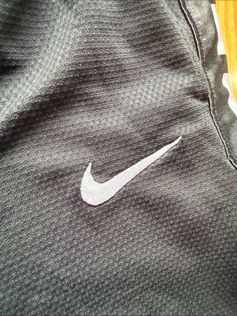 Nike Black Shorts with White Swoosh and Side Stripes
